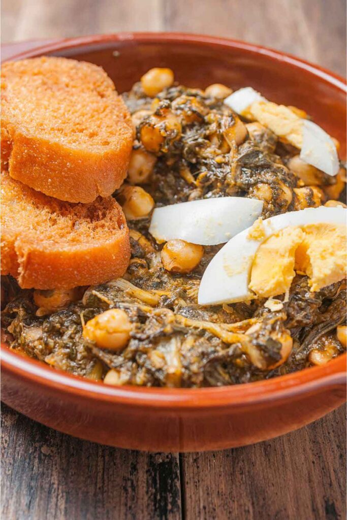 Traditional stew of spinach and chickpeas with slices of hard-boiled egg and crunchy bread. A beloved Lent-time dish that happens to be naturally vegetarian.