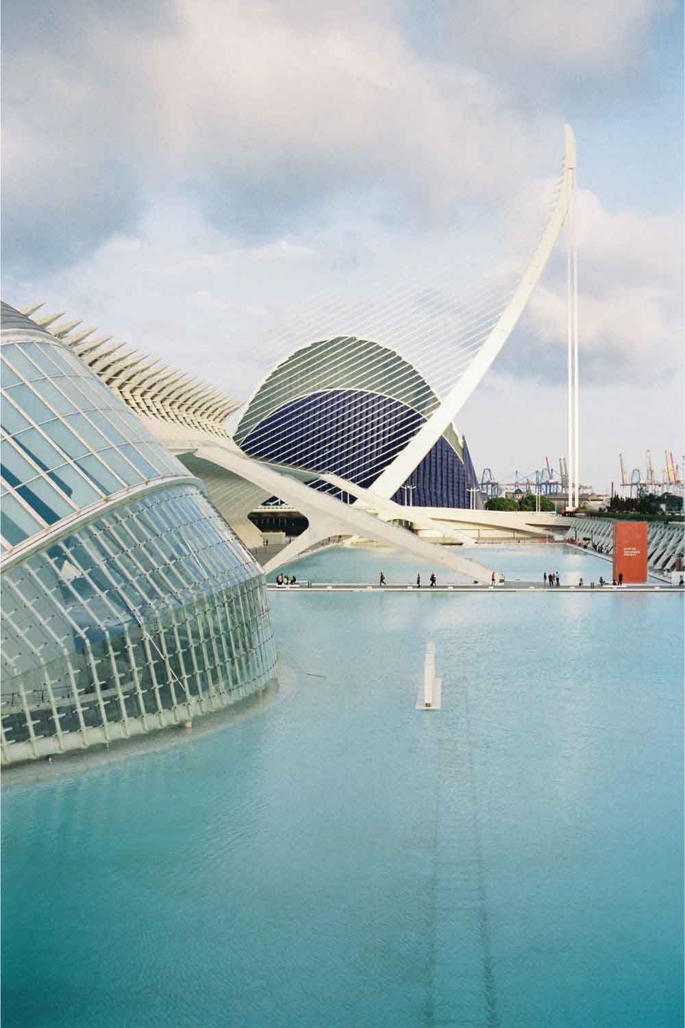 Futuristic architecture of the City of Arts and Sciences in Valencia, with modern buildings and reflecting pools.
