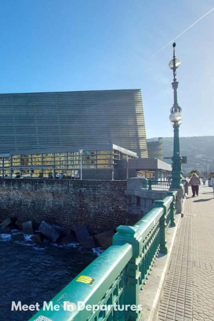Modern glass building of Kursaal Congress Centre viewed from Zurriola Bridge in San Sebastian, an architectural icon in the Basque coastal city.