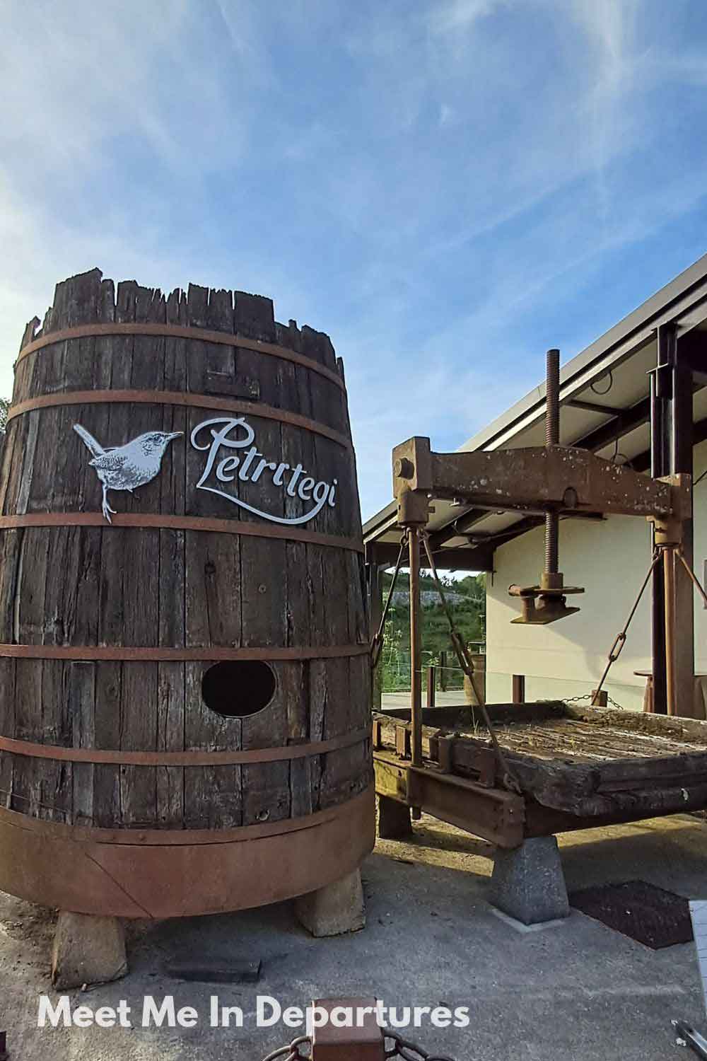 Large wooden cider barrel at Petritegi cider house near San Sebastian, a traditional Basque Country destination for sampling local sagardoa cider.