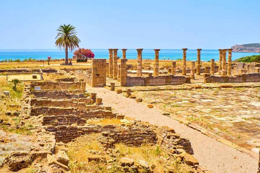 Baelo Claudia, Cádiz Ancient ruins of Baelo Claudia near Tarifa, Spain, with stone columns and walls overlooking the blue waters of the Strait of Gibraltar.