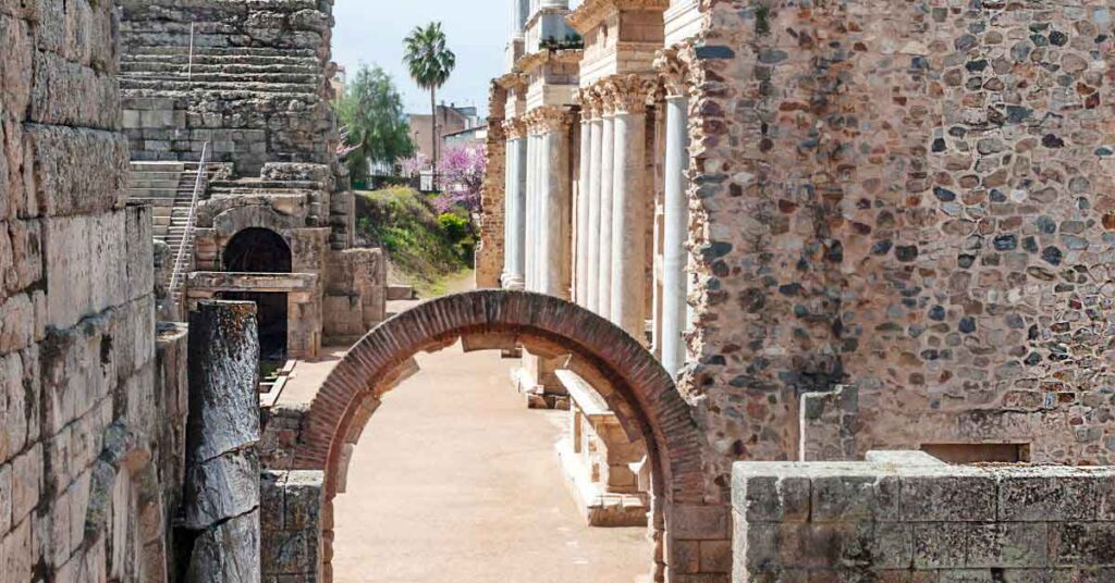 Best Roman Ruins in Spain: 13 Ancient Sites Worth Exploring 1 Stone arch and columns of the Roman Theatre in Mérida, Spain, part of a UNESCO World Heritage Site often listed among the Best Roman Ruins in Spain.