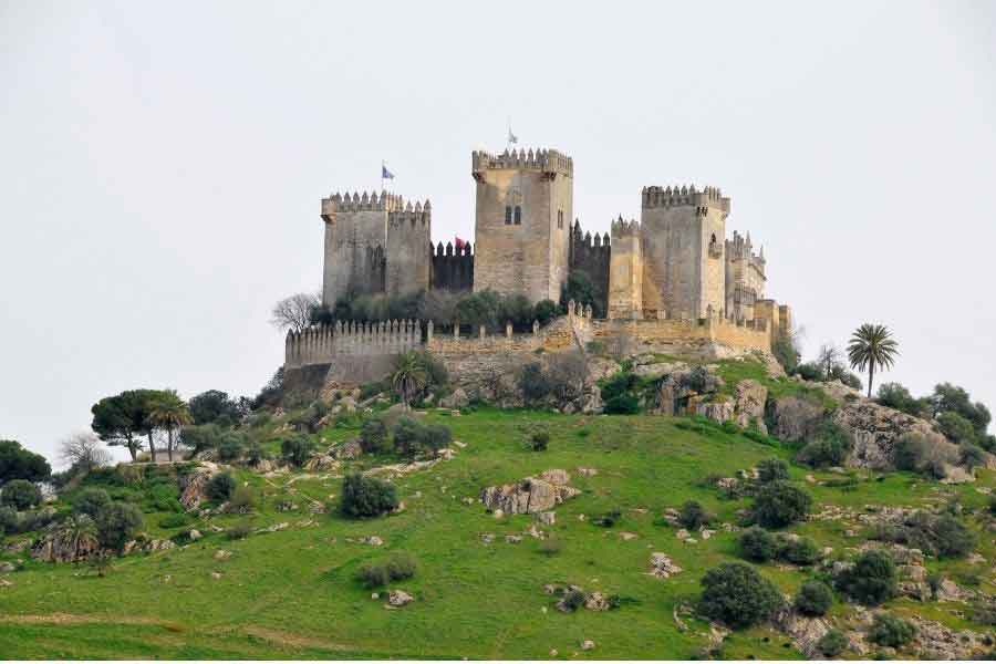 Castillo de Almodóvar del Río perched on a green hillside near Córdoba, a medieval fortress famous for its striking towers and panoramic views of Andalusia.