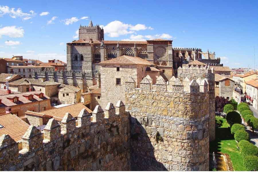 Ávila Cathedral rising above the medieval city walls, a unique blend of fortress and church architecture in one of Spain’s most well-preserved walled cities.