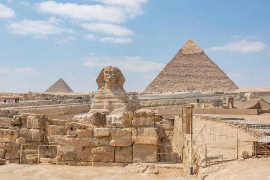 The Great Sphinx and Pyramids of Giza in Egypt under a blue sky, an iconic dream travel destination for history and archaeology enthusiasts