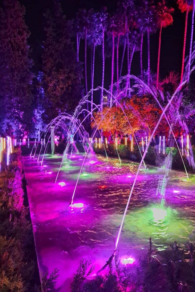 Naturaleza Encendida at The Alcazar Colourful illuminated fountains at the Alcázar gardens during the Naturaleza Encendida light show in Seville, a magical winter attraction held each Christmas season.