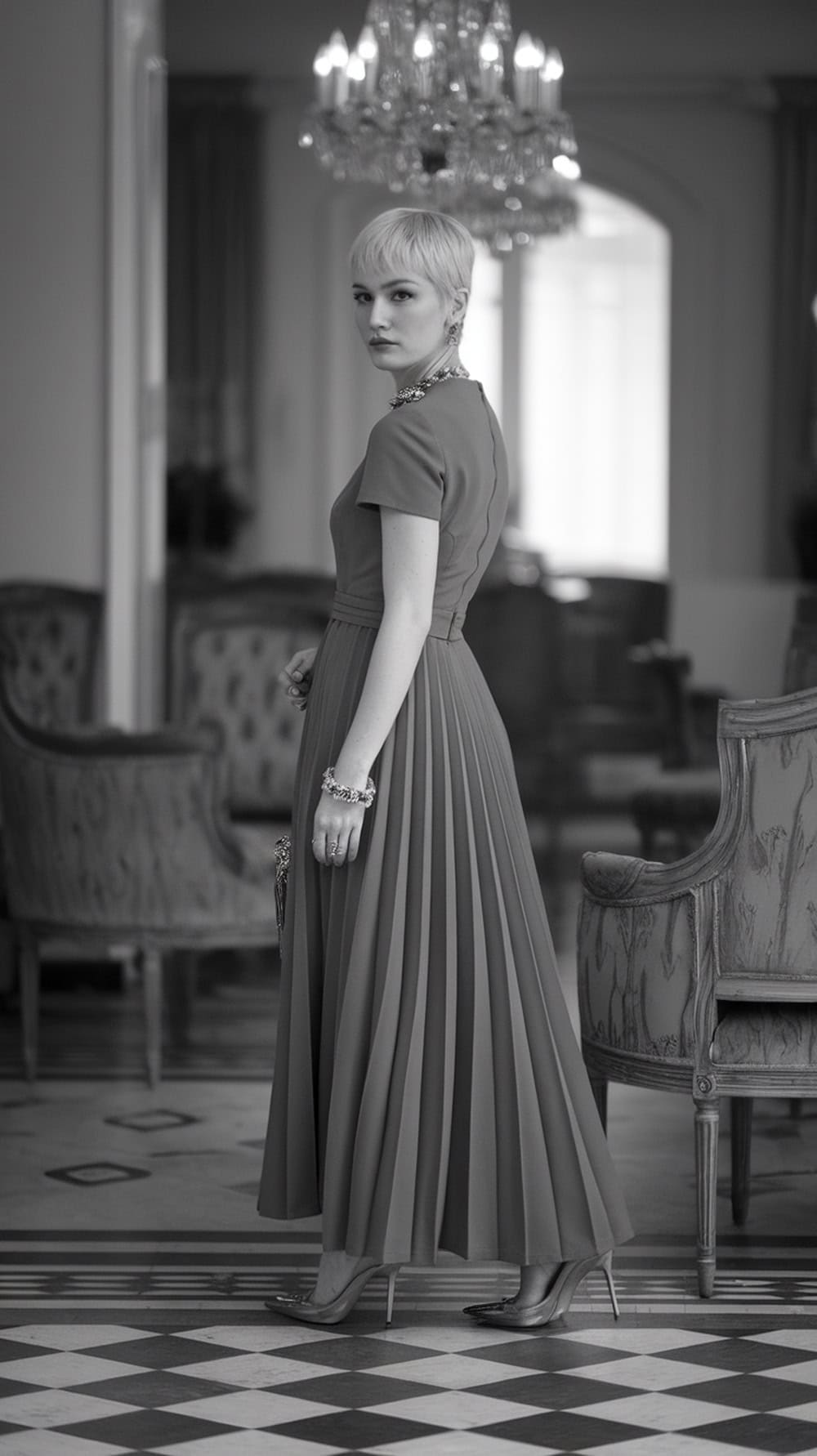 Model with a pixie haircut wearing a formal dress in an elegant setting