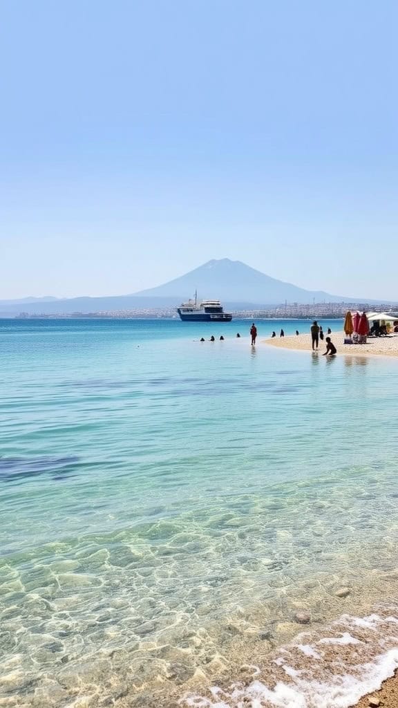 A scenic beach view in Naples, Italy, featuring clear waters, sandy shore, and Mount Vesuvius in the background.