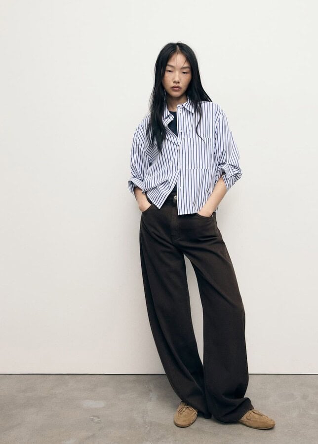A blue-and-white striped cropped shirt with button-down detail and boxy fit.