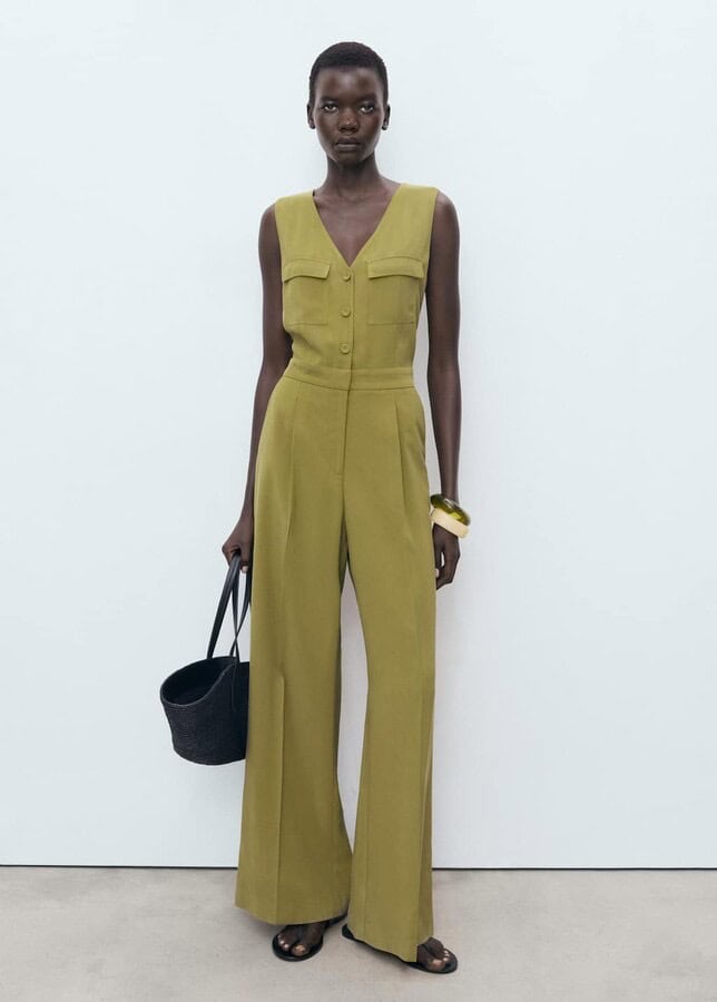 A full-length tailored jumpsuit with chest pockets and belted waist.