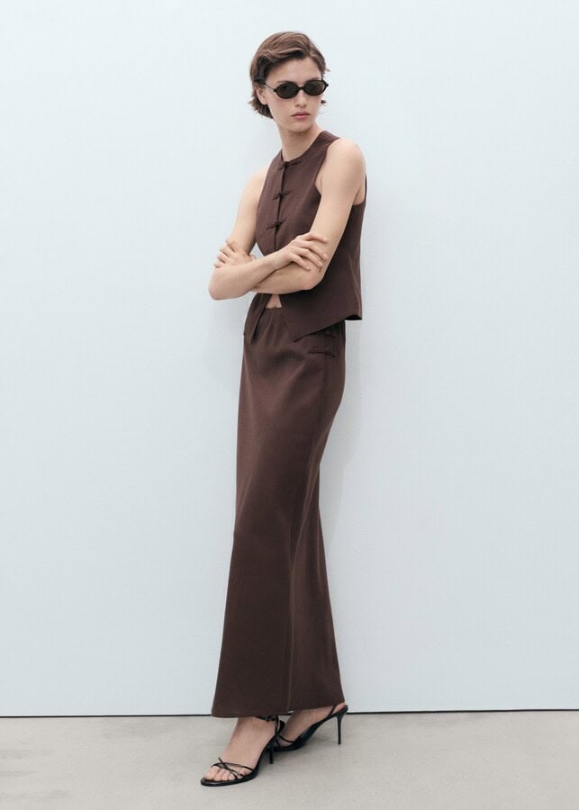 A straight-cut linen-blend skirt in neutral tones, knee-length with a tailored waistband.