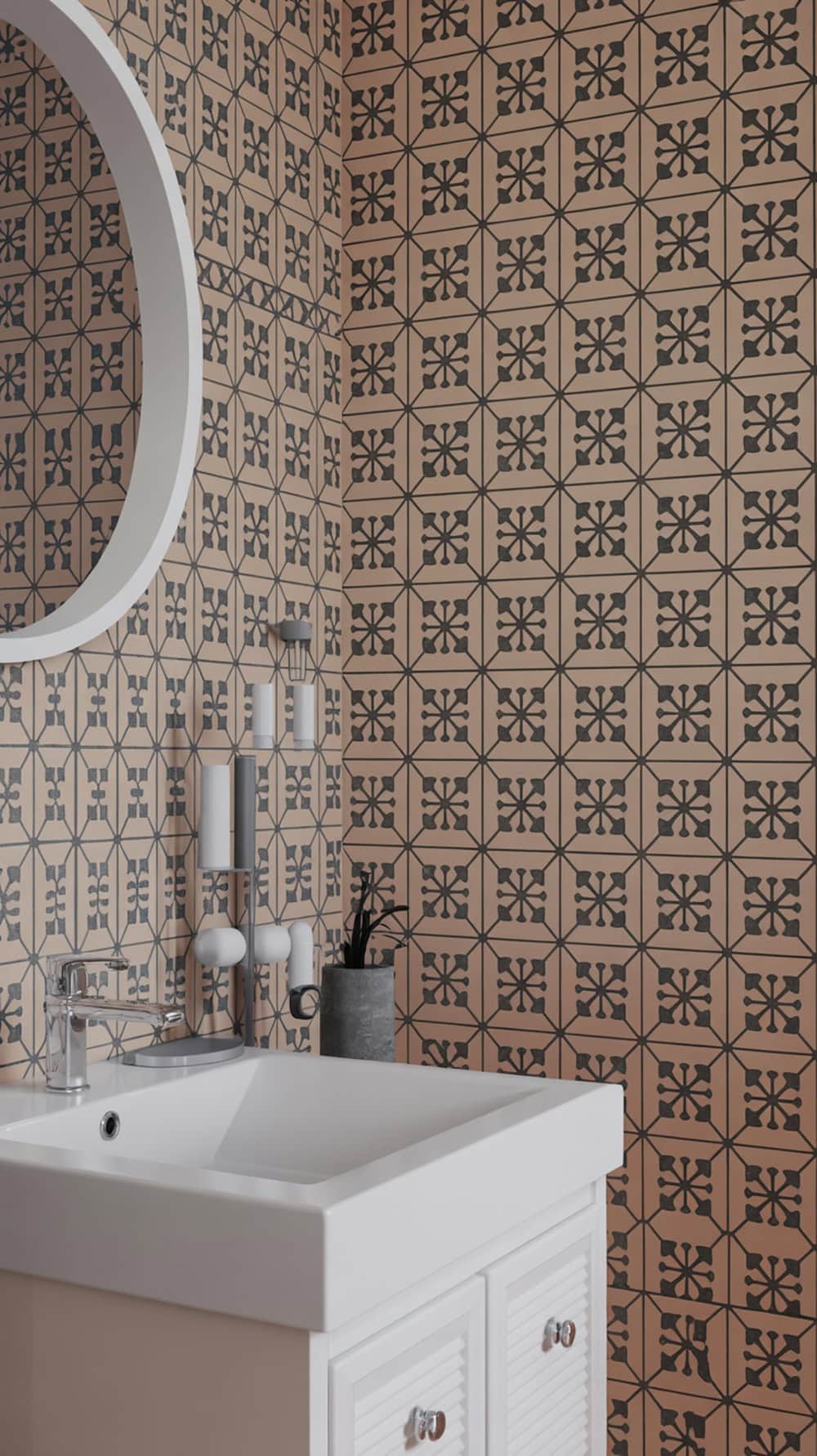 A bathroom featuring vibrant peach and black geometric tile patterns on the walls, with a white sink and round mirror.