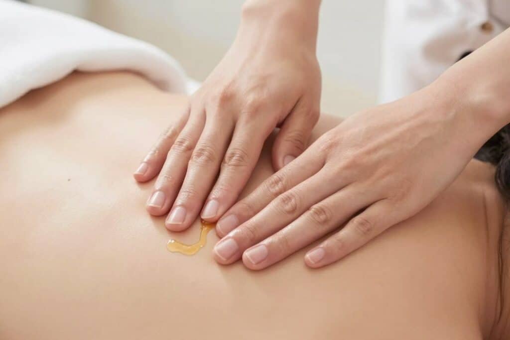 Demonstration of lymphatic massage technique using castor oil