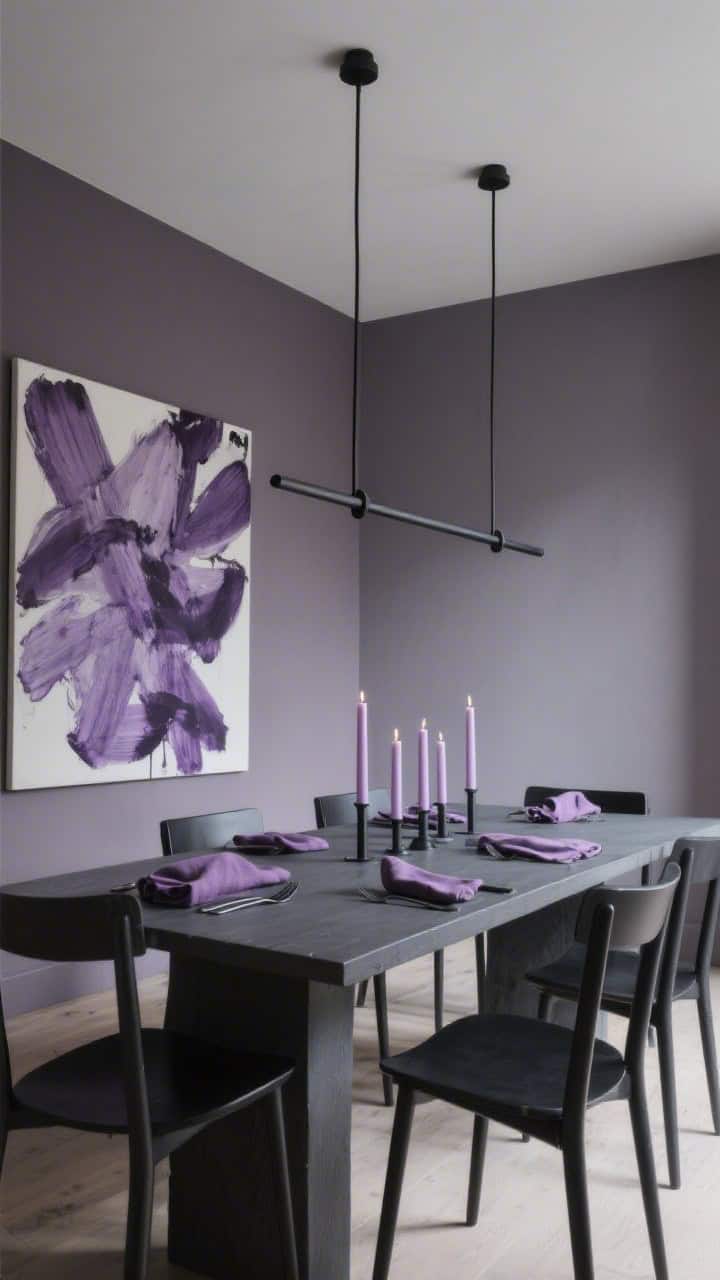 Wide dining room, modern moody drama: walls in muted heather; charcoal dining table with slim black chairs; a linear black chandelier centered above; table styling with plum linen napkins, pale lilac taper candles, matte black flatware; a single large abstract artwork in lavender and ink on the focal wall; subdued, gallery-like lighting.