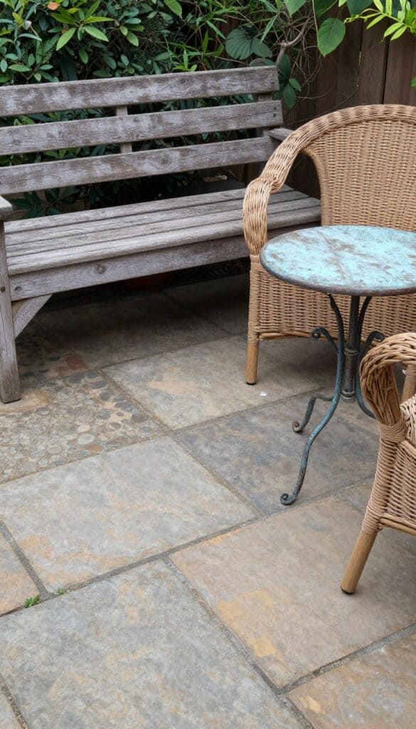 English country patio showing combination of weathered stone, aged wood, wicker and metal elements English country patio showing combination of weathered stone, aged wood, wicker and metal elements