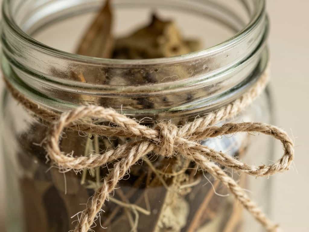close up of twine texture on mason jar with dried botanical elements