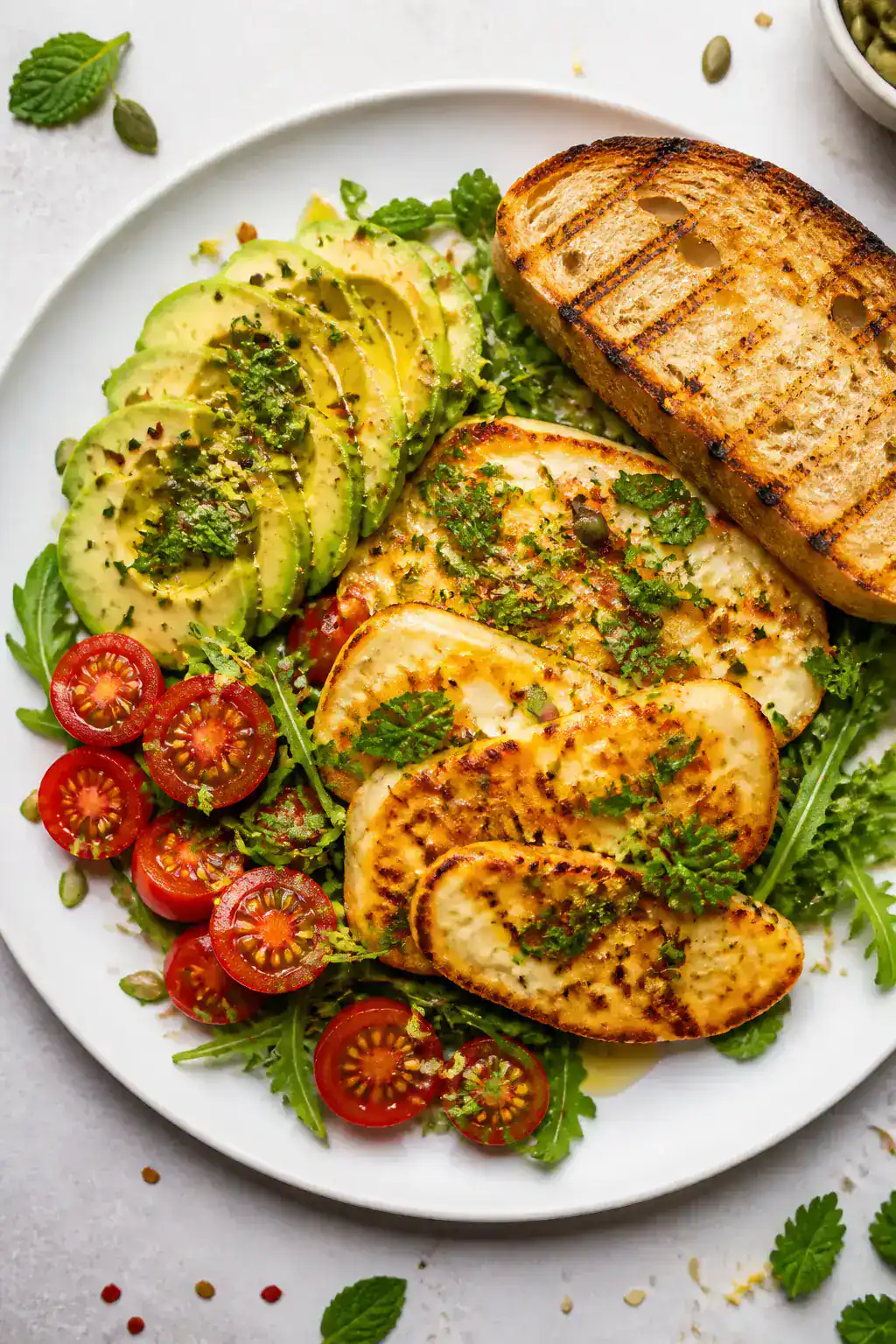 Tasty top view: Overhead shot of the assembled Halloumi and Avocado Breakfast Plate—fan of ripe av