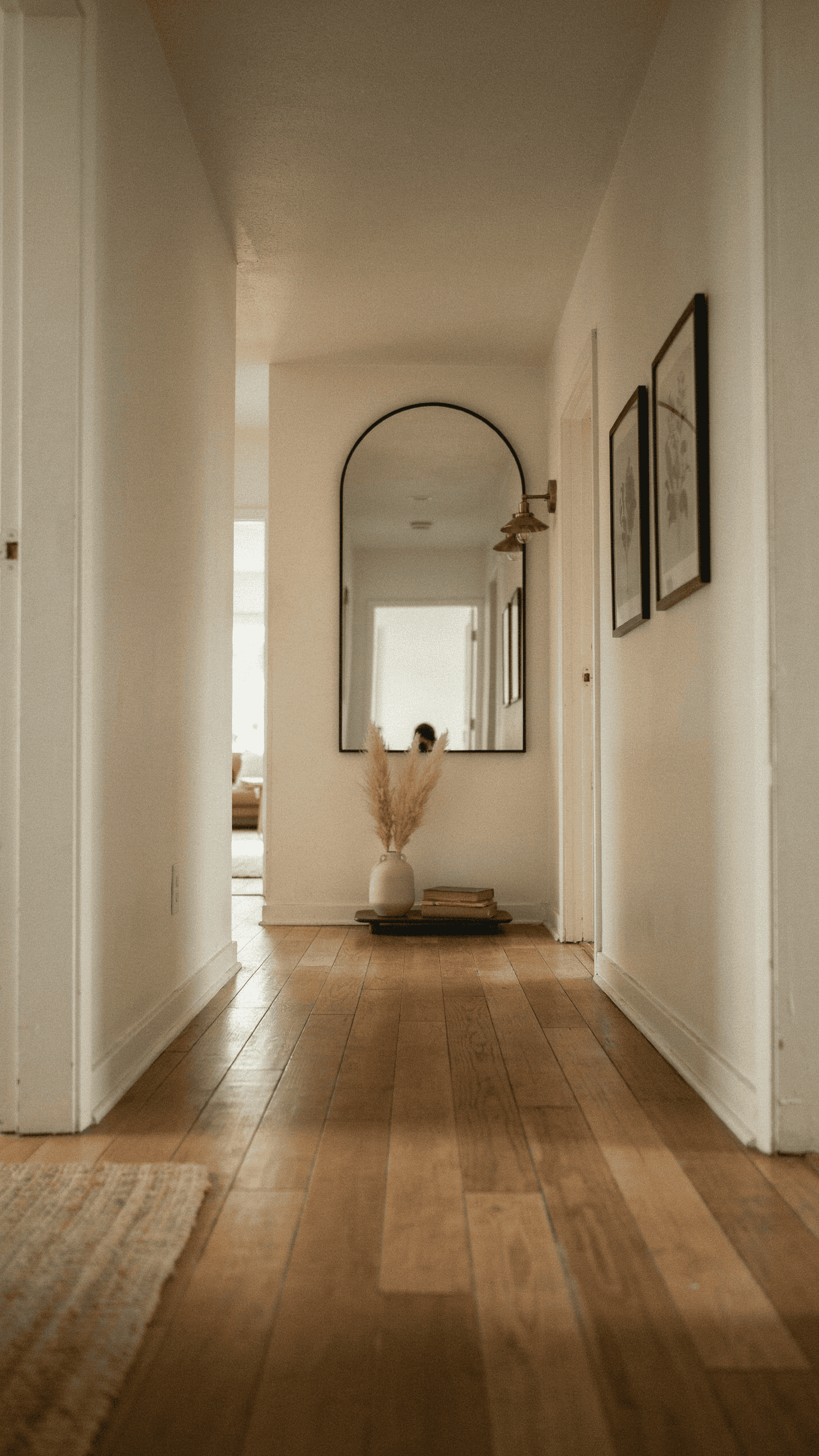 large arched mirror accent in a narrow hallway