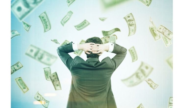 Man with hands behind head in money lottery windfall 