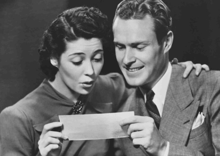 couple looking at paycheck