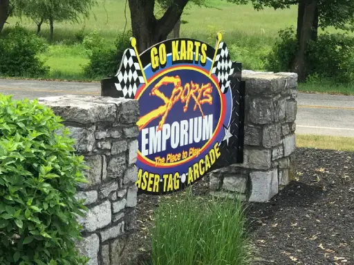 Sign for Sports Emporium, a family fun center near Mid State Baths in Carlisle.