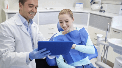 Dentist performing professional teeth cleaning and dental exam on a patient at Mid-Wilshire Dental Care