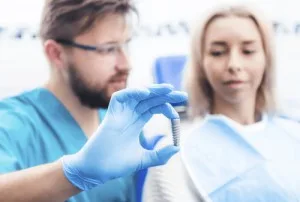 Close-up of a dentist placing a dental implant for a patient at Mid-Wilshire Dental Care, restoring missing teeth with precision