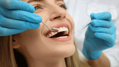 Patient smiling confidently after receiving cosmetic dentistry treatments like veneers and teeth whitening at Mid-Wilshire Dental Care