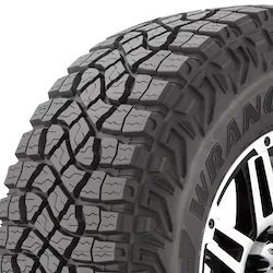 Off-road tire with rugged tread pattern for durability and traction.