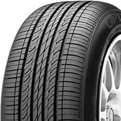 Close-up of a new car tire with detailed tread pattern.