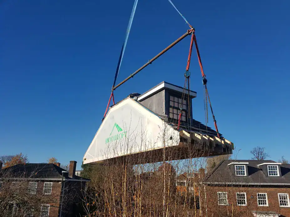 Crane lifting a pre-built Moduloft.