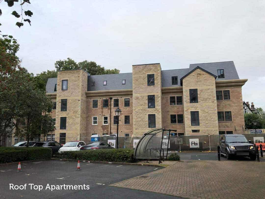 Modern roof top apartments with parking and landscaped surroundings.