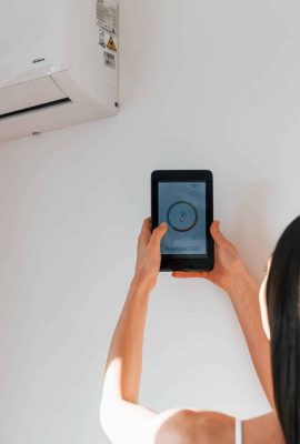 rear-view-of-woman-that-standing-indoors-with-phon-2023-11-27-04-49-28-utc-scaled.jpg