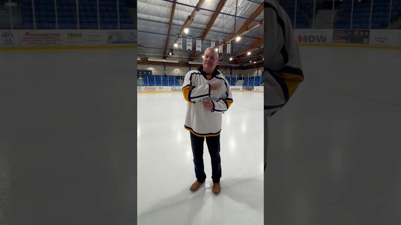 Ice hockey player standing on rink in MooseMedia sports arena.