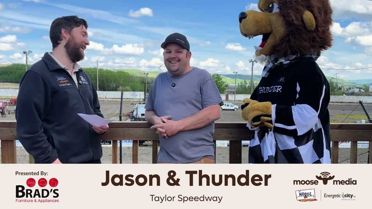 Smiling men talking with mascot at Jason & Thunder event at Taylor Speedway.