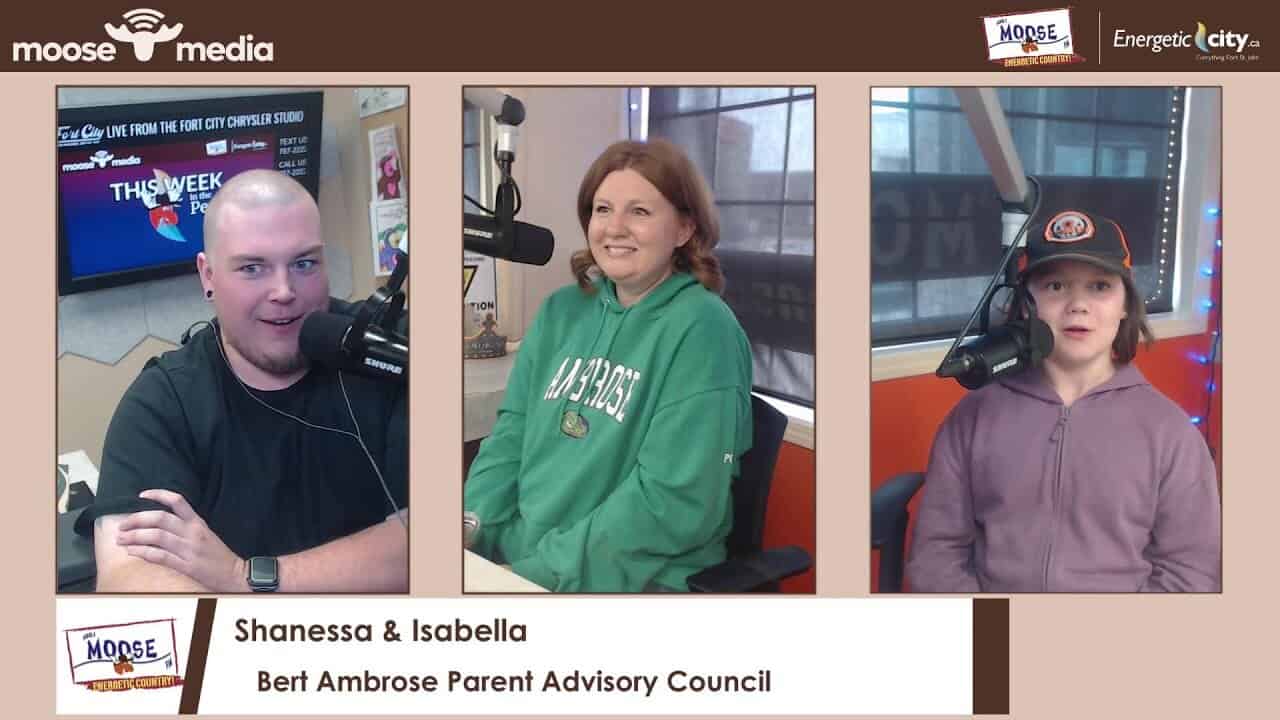 Young man with a shaved head speaking at MooseMedia radio station in Fort City.