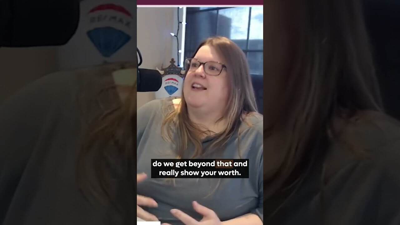 Female radio host speaking on microphone, engaging in conversation in a radio station setting.