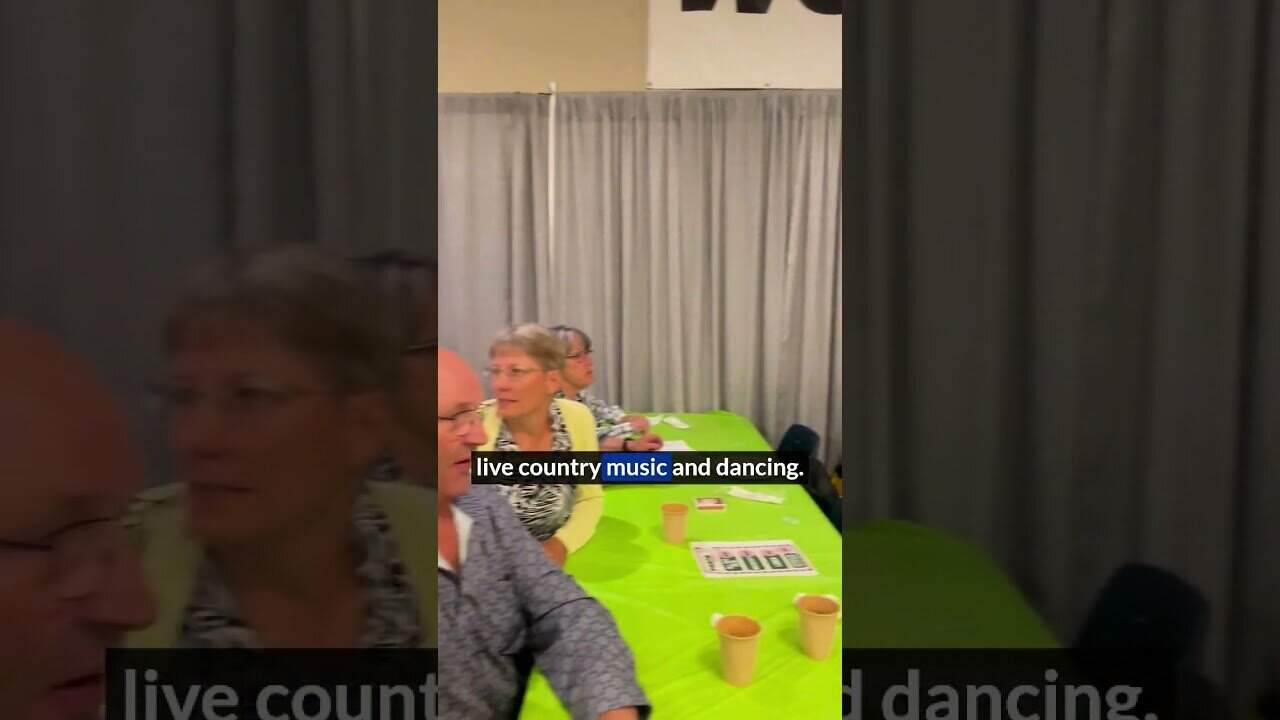 People enjoying live country music and dancing at MooseMedia event.