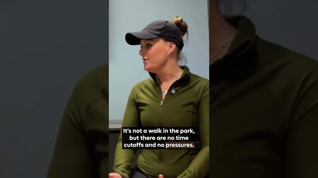 Women in outdoor gear speaking during an interview or meeting.