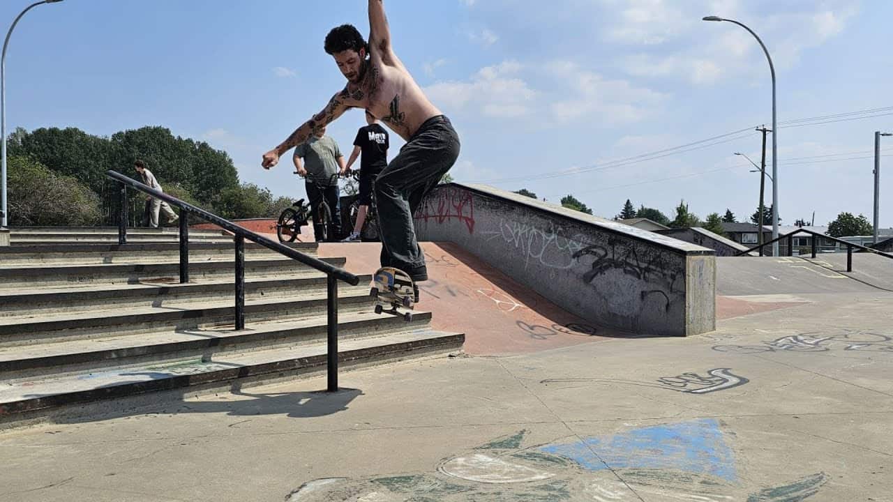 Skateboarder performing rail slide trick at MooseMedia skatepark in FSJ.