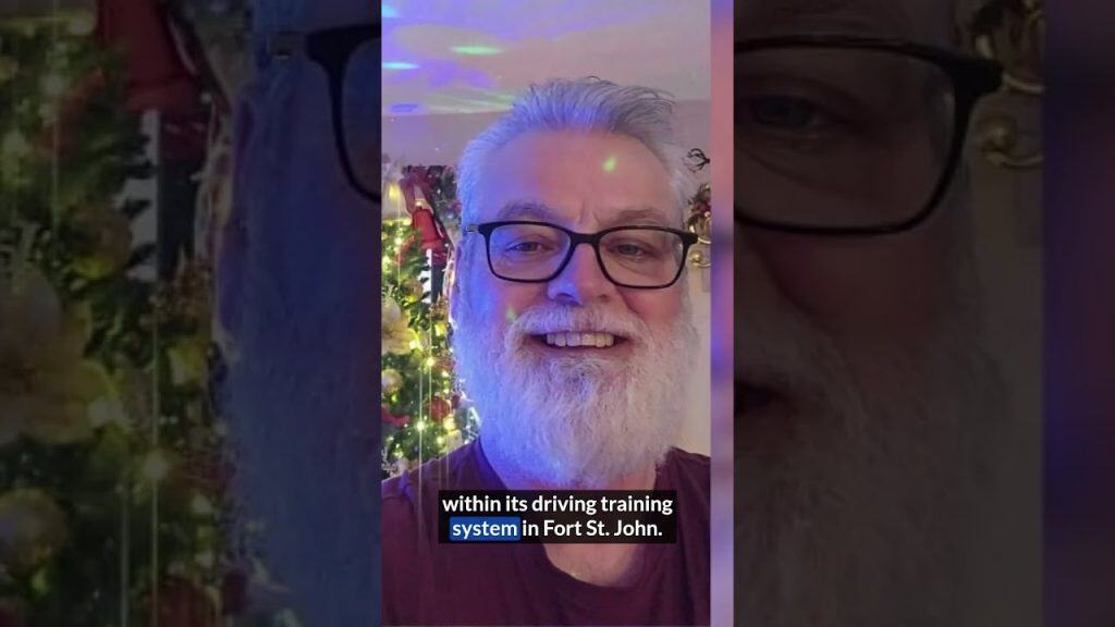 Close-up of smiling man with glasses near Christmas tree.