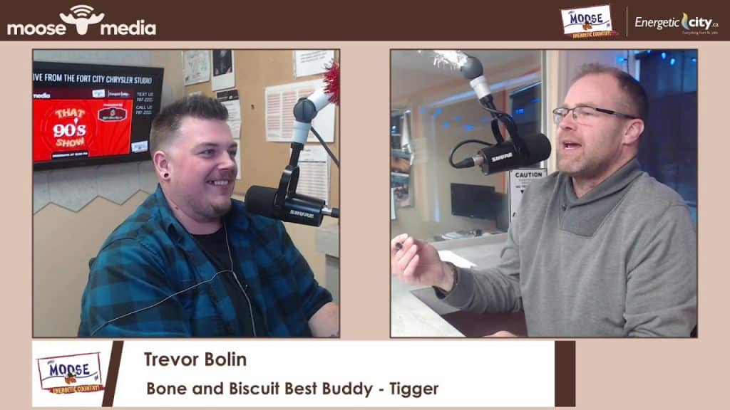 Young man and host speaking in radio studio.