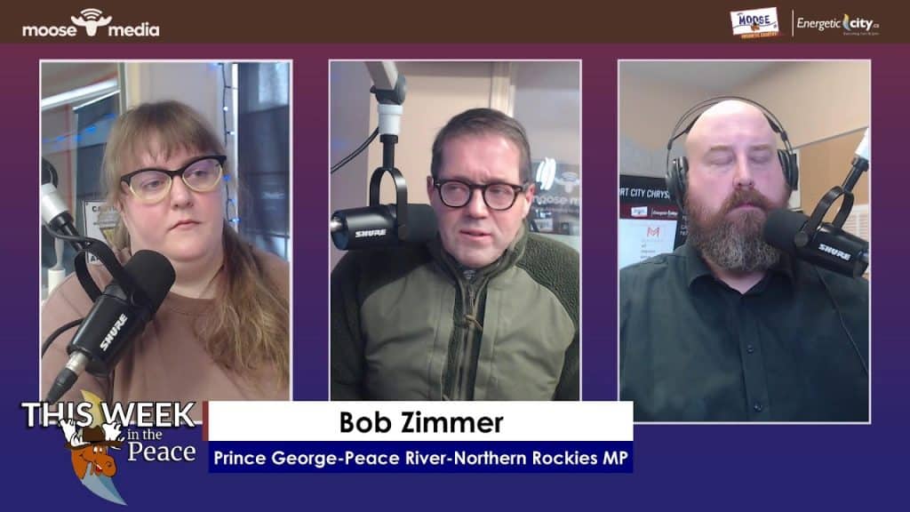 Radio hosts discussing community issues in a studio setting.