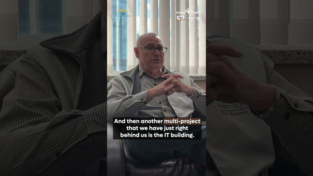 Man discussing upcoming council projects in the IT building for 2026.