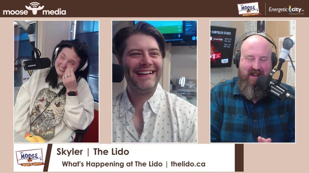 Radio hosts smiling during a live broadcast at The Lido.