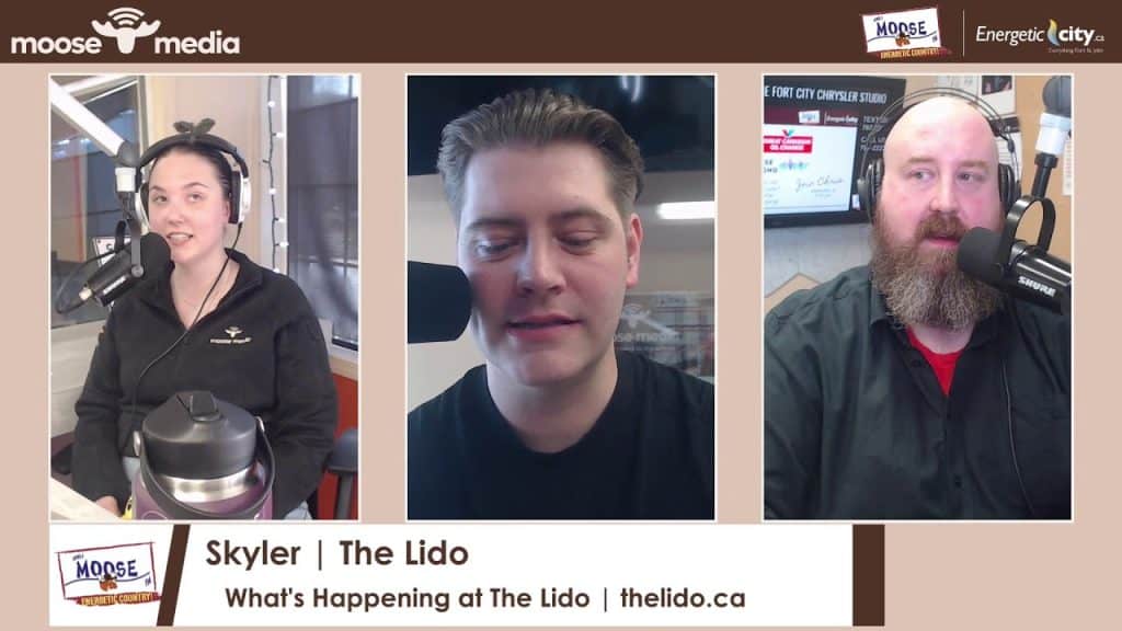 Podcast hosts recording at The Lido during What's Happening event.