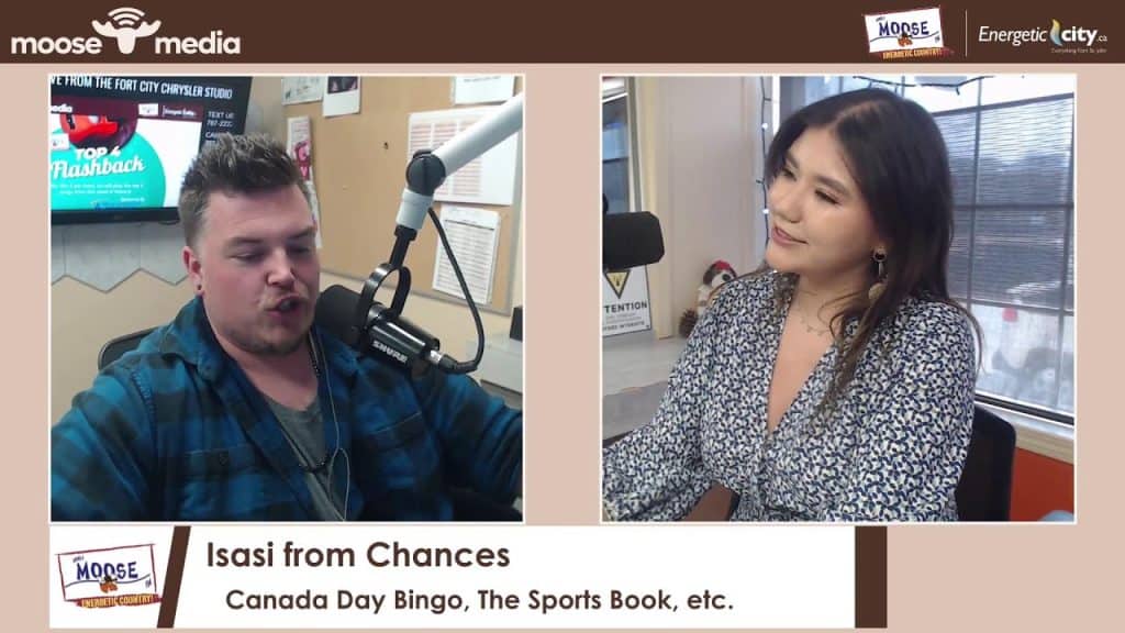 Two people in a radio studio during an interview at MooseMedia FSJ.