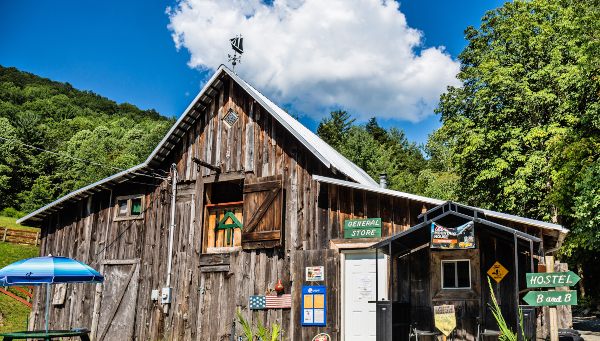 Charming rustic mountain hostel with scenic outdoor views.