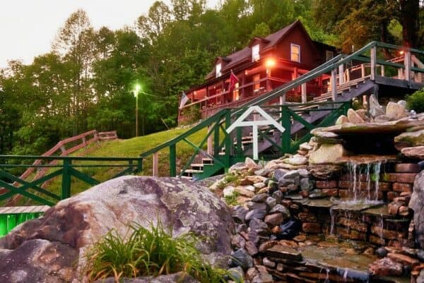 Cozy mountain cabin surrounded by lush trees and scenic waterfalls at Mountain Harbour.