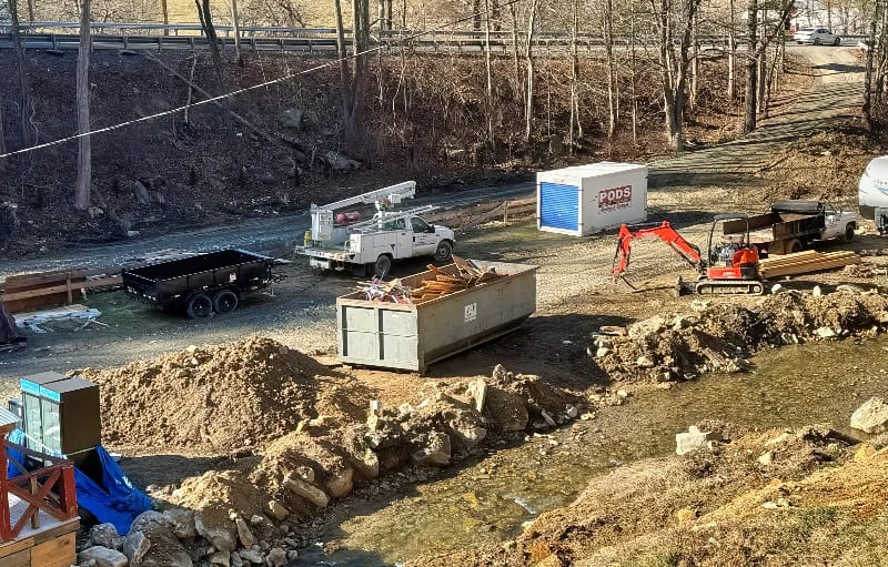 Excavation site at Mountain Harbour construction project with heavy equipment and materials.